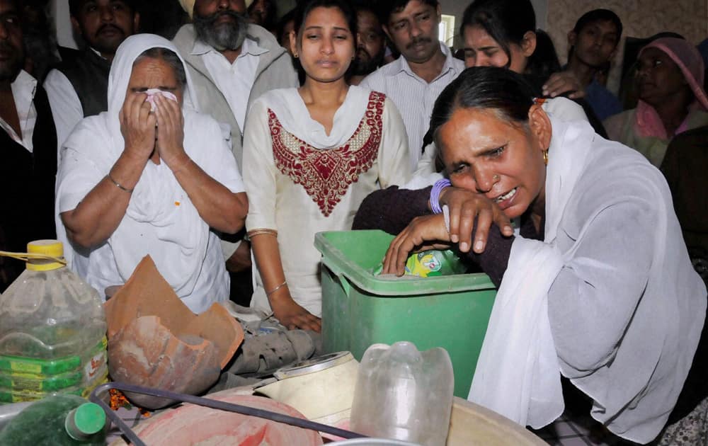 Sarabjit Singh`s family weeps as they go through his belongings which were received from Pakistan at their native village Bhikhiwind, about 45 km from Amritsar.
