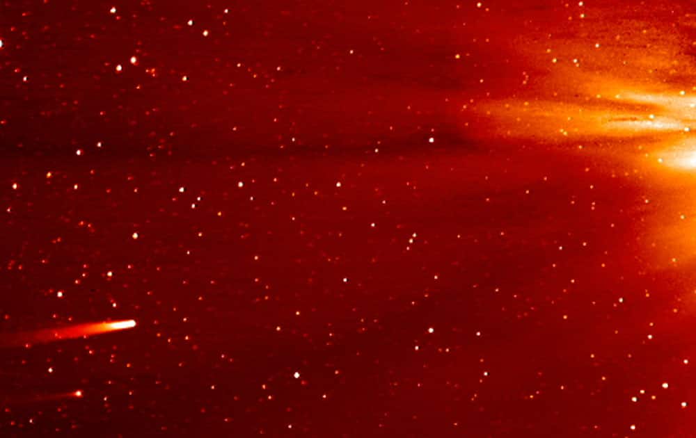 In this frame grab taken from enhanced video made by NASA`s STEREO-A spacecraft, comet ISON, left, approaches the sun.