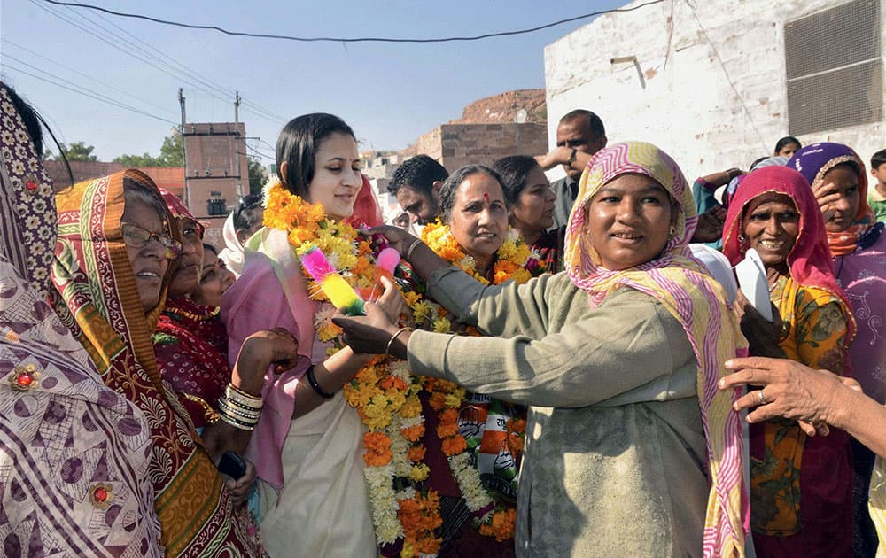 Rajasthan Chief Minister Ashok Gehlot`s wife Sunita Gehlot (2nd R) and daughter-in-law Himanshi campaign in Sardarpura Assembly in Jodhpur.
