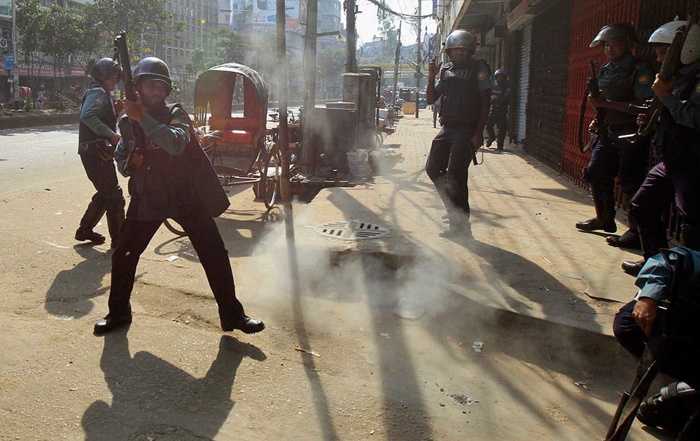 A homemade bomb explodes in front of Bangladeshi policemen during a nationwide strike in Dhaka, Bangladesh.
