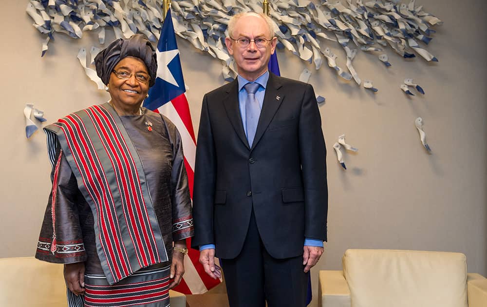 European Council President Herman Van Rompuy, right, poses for photographers with Liberia`s President Ellen Johnson Sirleaf in his office at the EU Council building in Brussels.