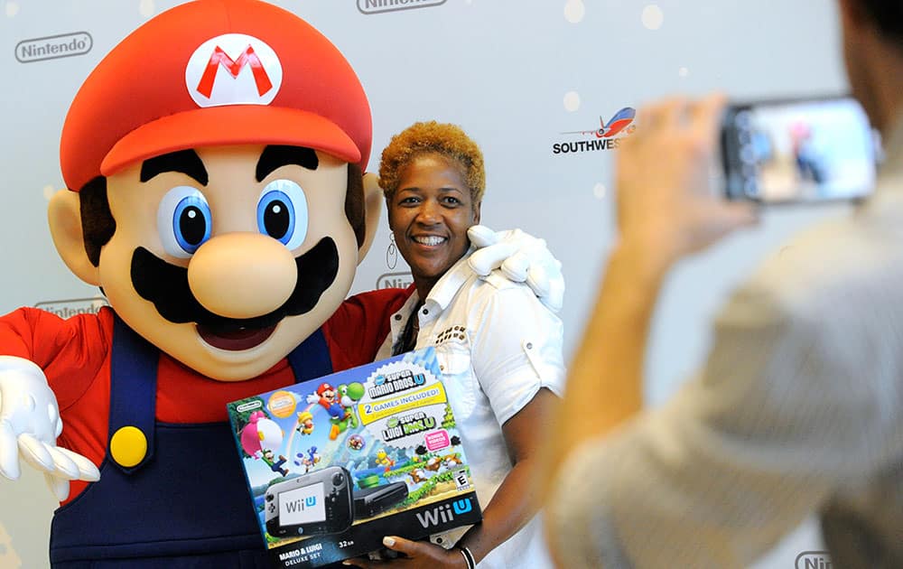 Dorcas H. from La Place, LA, is one of the first passengers to thank Mario for giving away free Wii U systems on a Southwest Airlines flight from New Orleans to Dallas Love Field in Dallas, TX in Dallas.