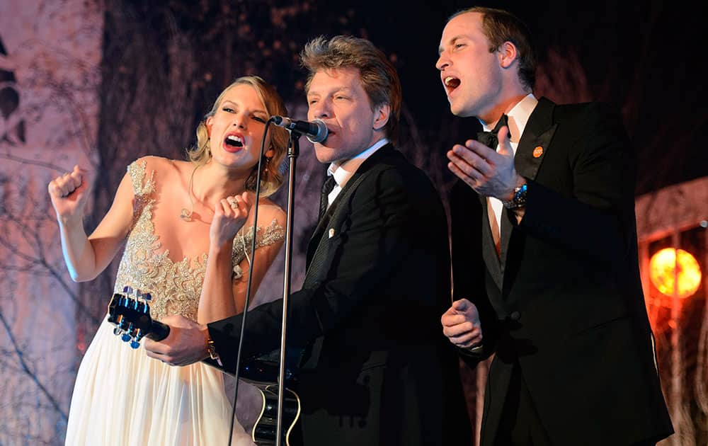 Britain`s Prince William, the Duke of Cambridge, right, sings with Taylor Swift, right, and Jon Bon Jovi at the Centrepoint Gala Dinner at Kensington Palace in London.