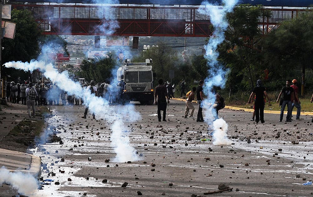 Tear gas flies during clashes between police and protesters near the National Autonomous University in Tegucigalpa, Honduras.