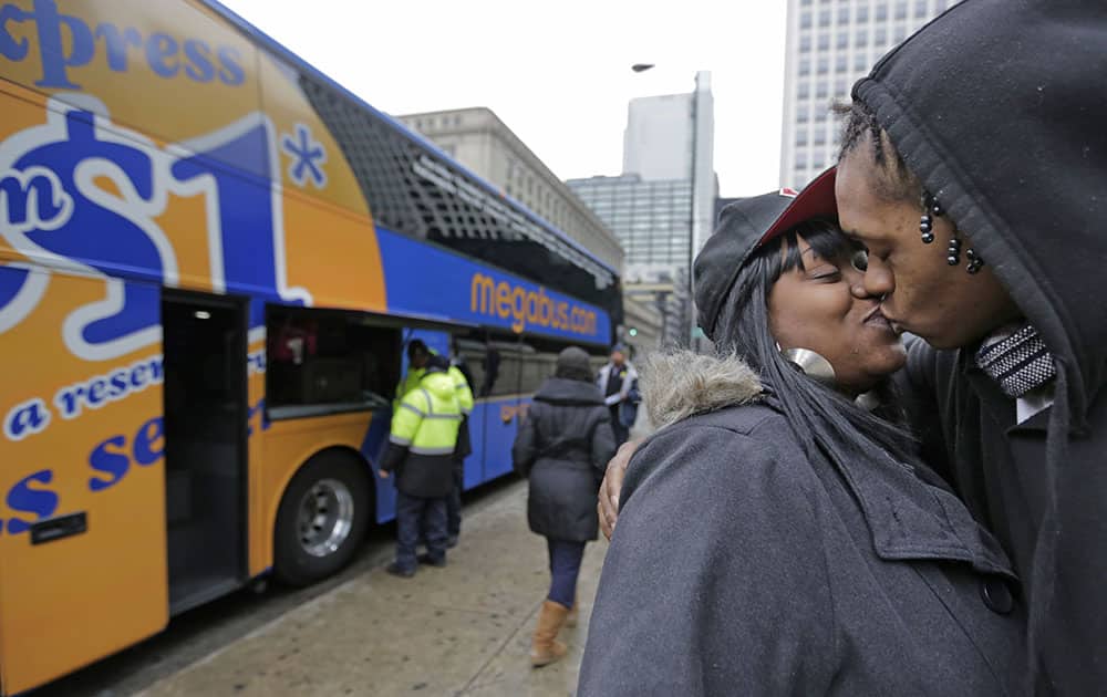 Shay Owens kisses her boyfriend Bryan Jordan before boarding a Megabus for a trip to Atlanta, in Chicago.