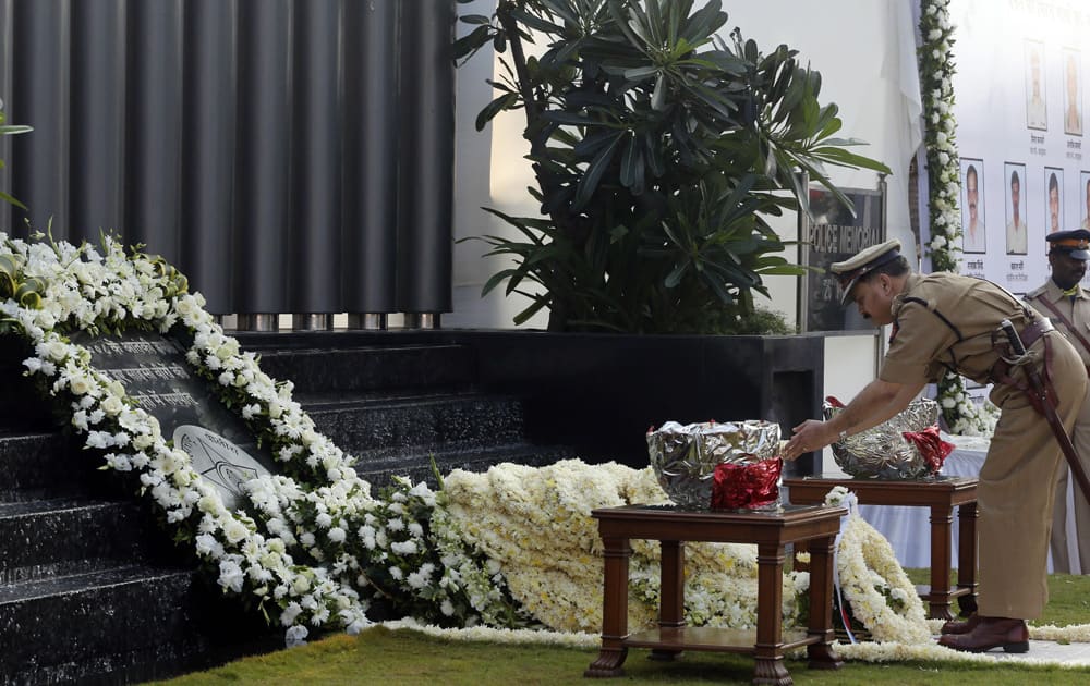 A police officer offers tribute at the memorial for police and uniformed personnel who lost their lives in the 2008 Mumbai terror attacks during the 5th anniversary of the attack in Mumbai.
