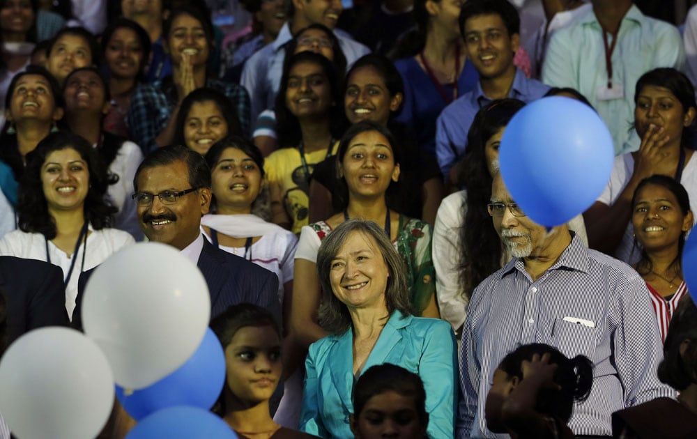 Kia Scherr, center in blue, who lost her husband and daughter in 2008 Mumbai terror attack, participates in a gathering to pledge for peace ahead of the fifth anniversary of the 2008 Mumbai terror attack Friday, in Mumbai.