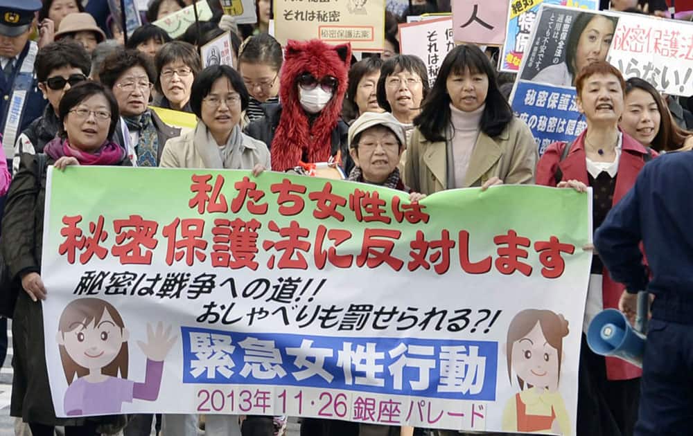 Demonstrators march during a protest against a state secrecy law, at Tokyo`s Ginza shopping district.