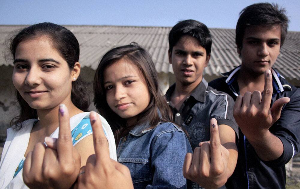 First time voters show their marked fingers after casting votes for Assembly elections in Indore, Madhya Pradesh.