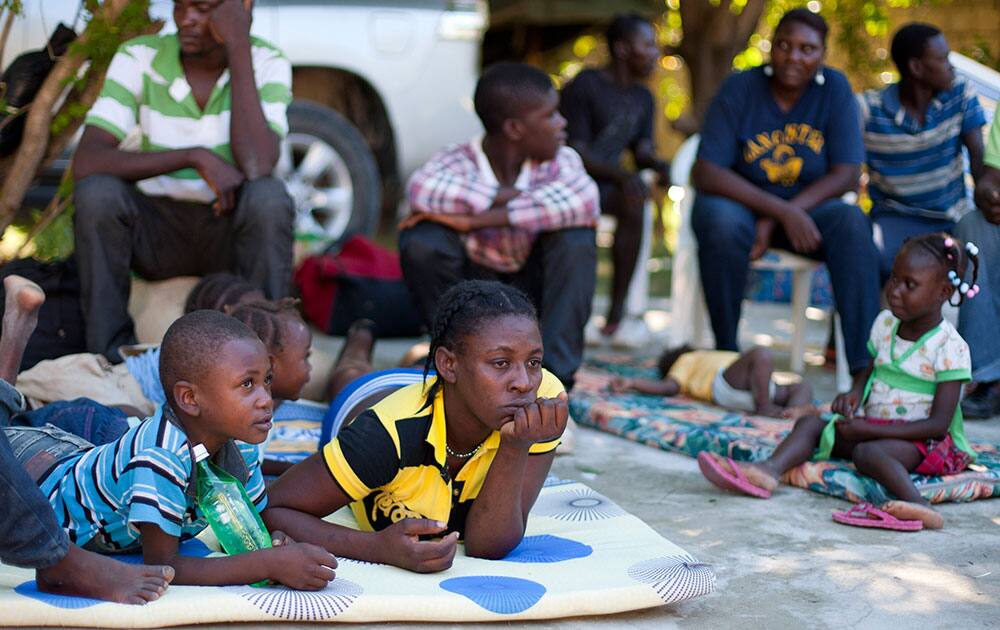 Haitian Jeanne Dorissaint, 26, rests with her children who were born in the Dominican Republic, at a shelter after they were deported by Dominican Republic authorities, in Croix-des-Bouquets, Haiti.