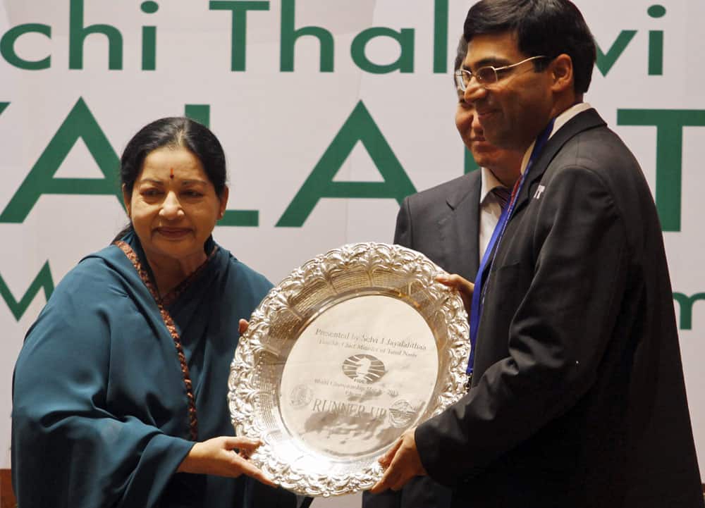 India`s Viswanathan Anand, right, poses with the runner-up trophy presented by Chief Minister of Tamil Nadu state J. Jayalalitha after loosing his title against Norway`s Magnus Carlsen in the World Chess Championship, in Chennai.