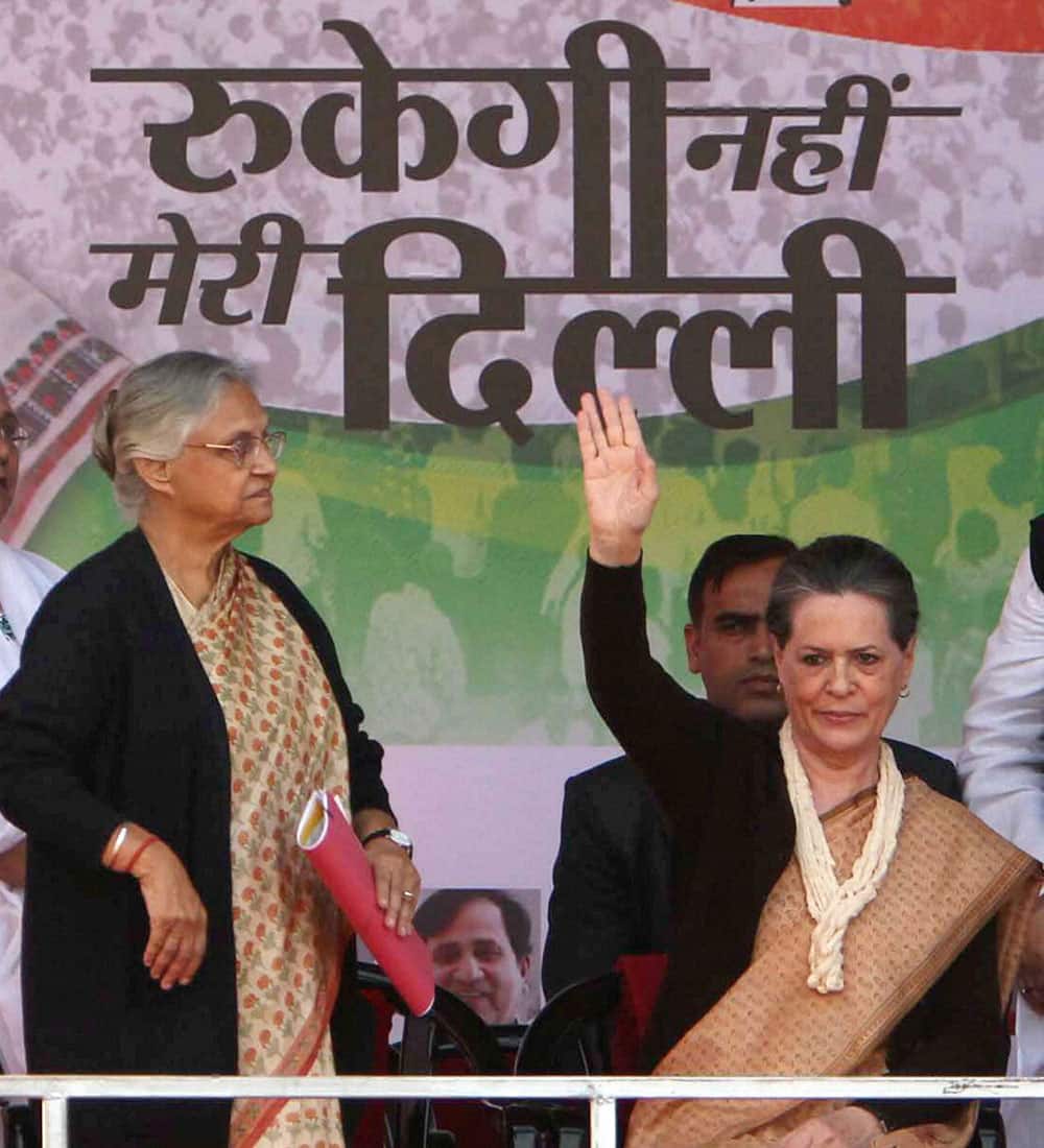 Congress President Sonia Gandhi with Delhi Chief Minister S Dikshit waves during an election rally in New Delhi.