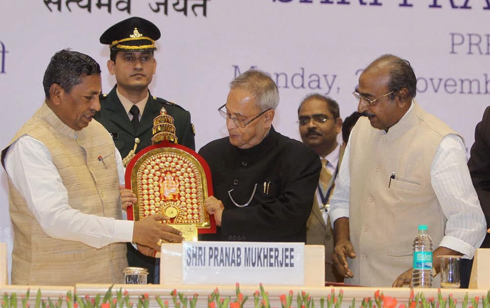 President Pranab Mukherjee receives memonto from Union Minister of State For Micro,Small And Medium Enterprises (Independent Charge)(L), K H Muniyapp during the Coir Board Diamond Jubilee Celebrations in New Delhi.