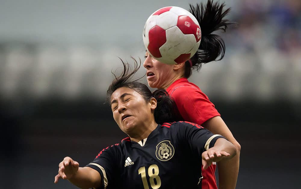 Mexico`s Stephany Mayor, left, and Canada`s Marie-Eve Nault vie for the ball during the second half of an international friendly soccer game in Vancouver, British Columbia.