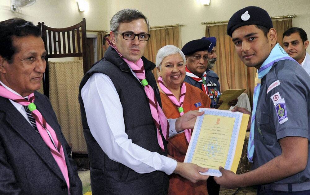 Jammu and Kashmir Chief Minister Omar Abdullah (C) honouring J&K cadet with Rashtrapati Puraskar to Scouts and Guides of Jammu and Kashmir Chapter on behalf of the President of India Scouts & Guides Awards.