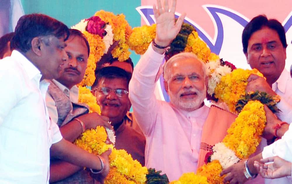BJP Prime Ministerial candidate Narendra Modi is garlanded during an election rally in Chittorgarh.