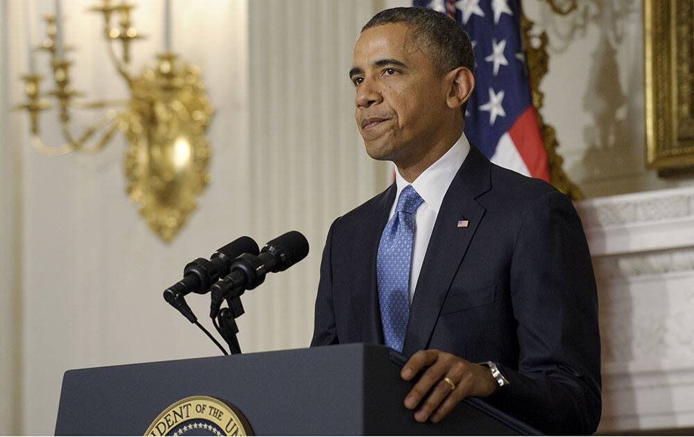 President Barack Obama pauses after concluding his statement on the historic agreement reached between six nations and Iran at an evening address in the State Dining Room at the White House in Washington.
