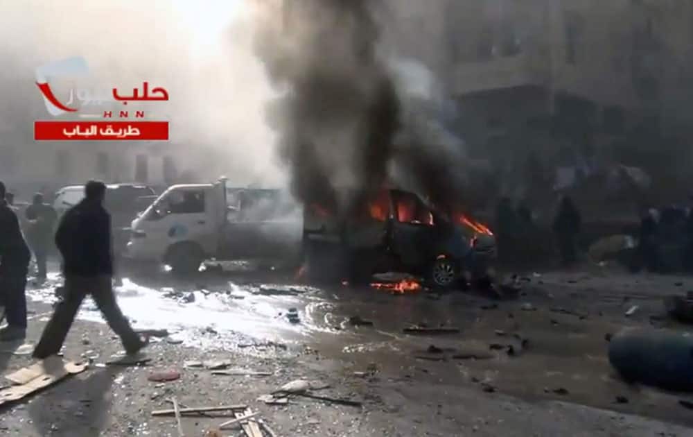 This image taken from a video obtained from the Sham News Network, which is consistent with independent AP reporting, shows burning vehicles and damage as a result of intense shelling by government forces in Aleppo, Syria.