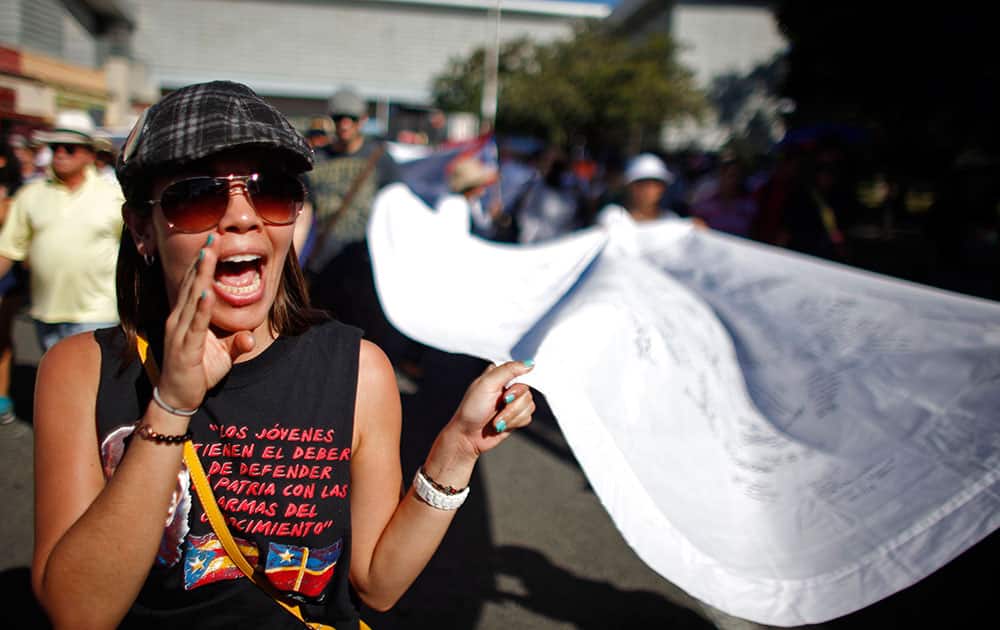 A woman shouts slogans during a march demanding the release of former militant Oscar Lopez in San Juan, Puerto Rico.