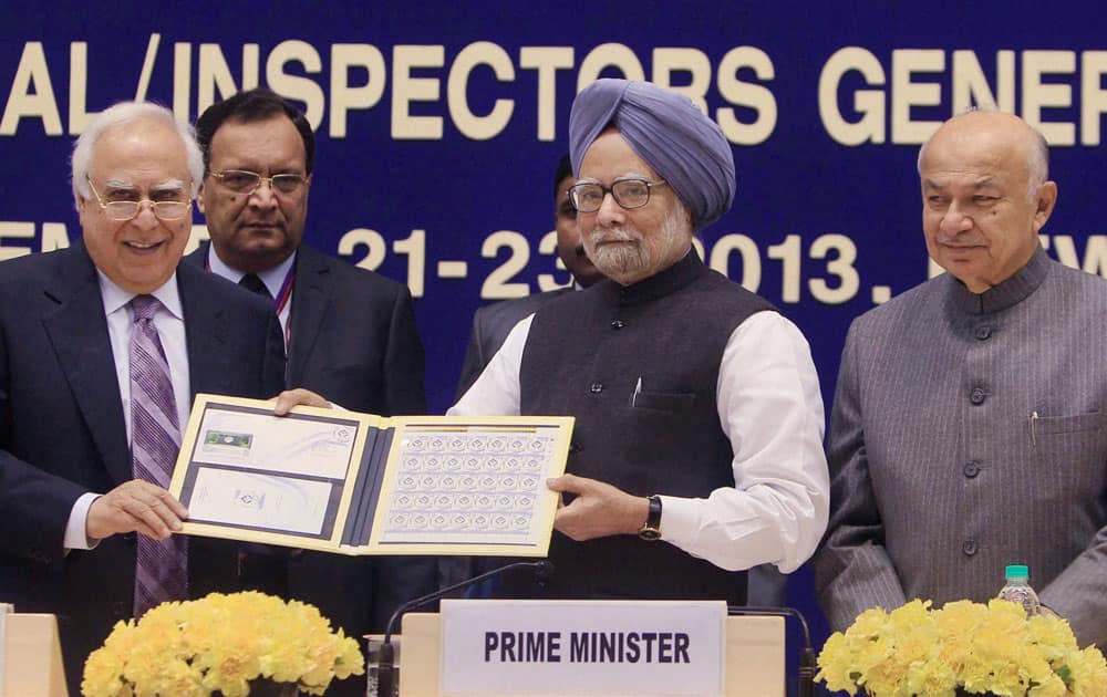 Prime Minister Manmohan Singh with Minister for Communications and IT, Kapil Sibal releases a commemorative stamp to mark the completion of 125 years of the Intelligence Bureau at the All India Conference of DGPs / IGPs at Vigyan Bhavan in New Delhi.
