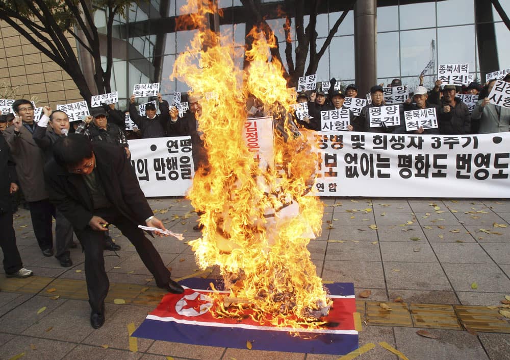 A man burns an effigy of North Korean leader Kim Jong Un and a North Korean flag during a rally to mark the the third anniversary of North Korea’s artillery attack on the Yeonpyeong island, in Seoul.