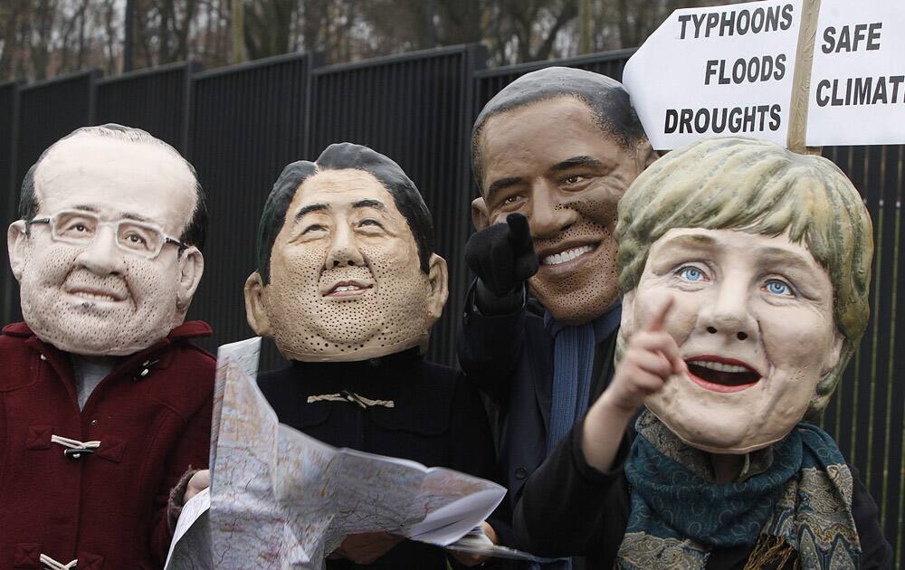 Climate activists protest acting in the role world leaders who search for a way , in front of the U.N. climate change conference at the National Stadium in Warsaw, Poland.