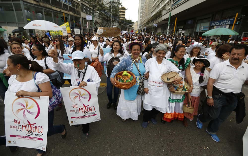 People march to protest physical abuse of women and in support of Colombia`s peace talks currently underway in Cuba, in Bogota, Colombia.