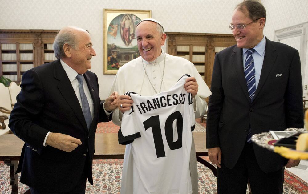 Pope Francis is presented with a jersey reading his name during a meeting with FIFA president Joseph Sepp Blatter at the Vatican.