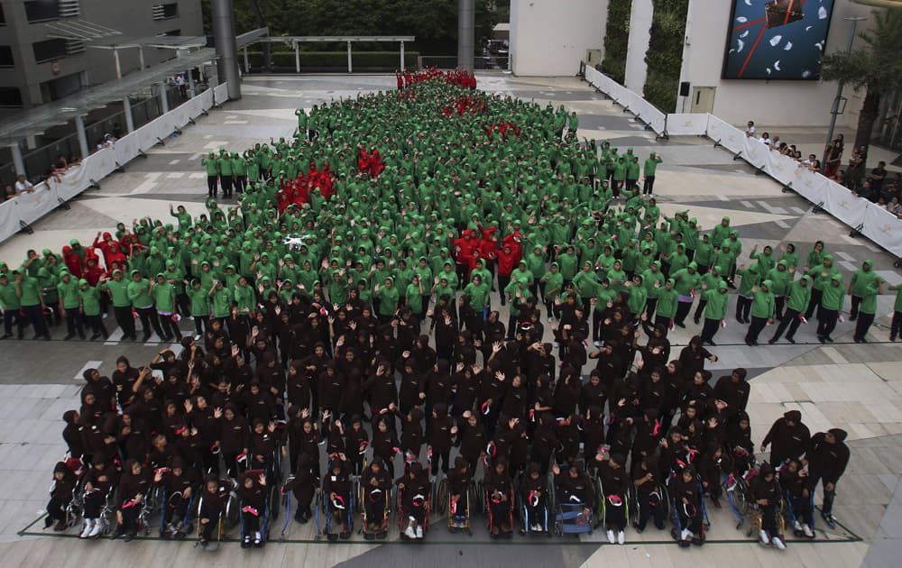 Dressed in red, green and black hoodies, 852 Thai students gather together to break the Guinness World Record for forming the largest human Christmas tree in Bangkok, Thailand.