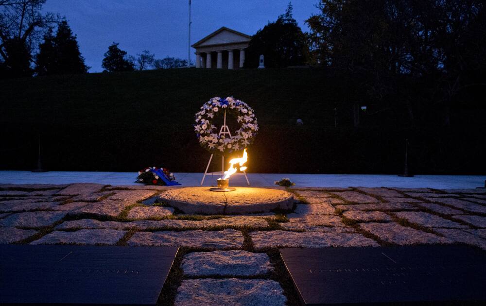 The eternal flame shines in the early morning light at the grave of John F. Kennedy at Arlington National Cemetery on the 50th anniversary of Kennedy`s death.