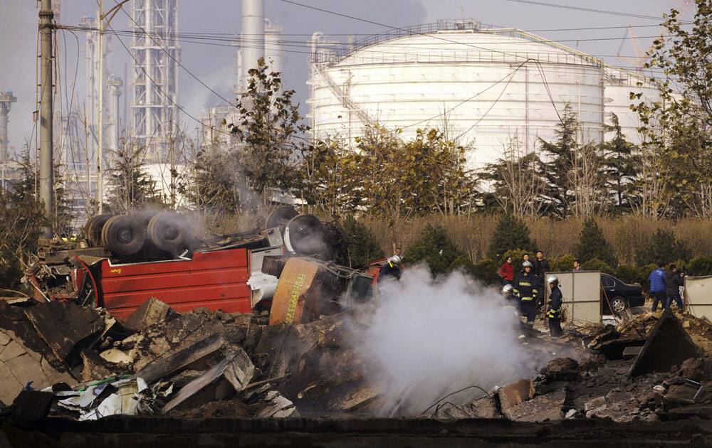 Firefighters work on a damaged site following a pipeline explosion in Qingdao in east China`s Shandong province.