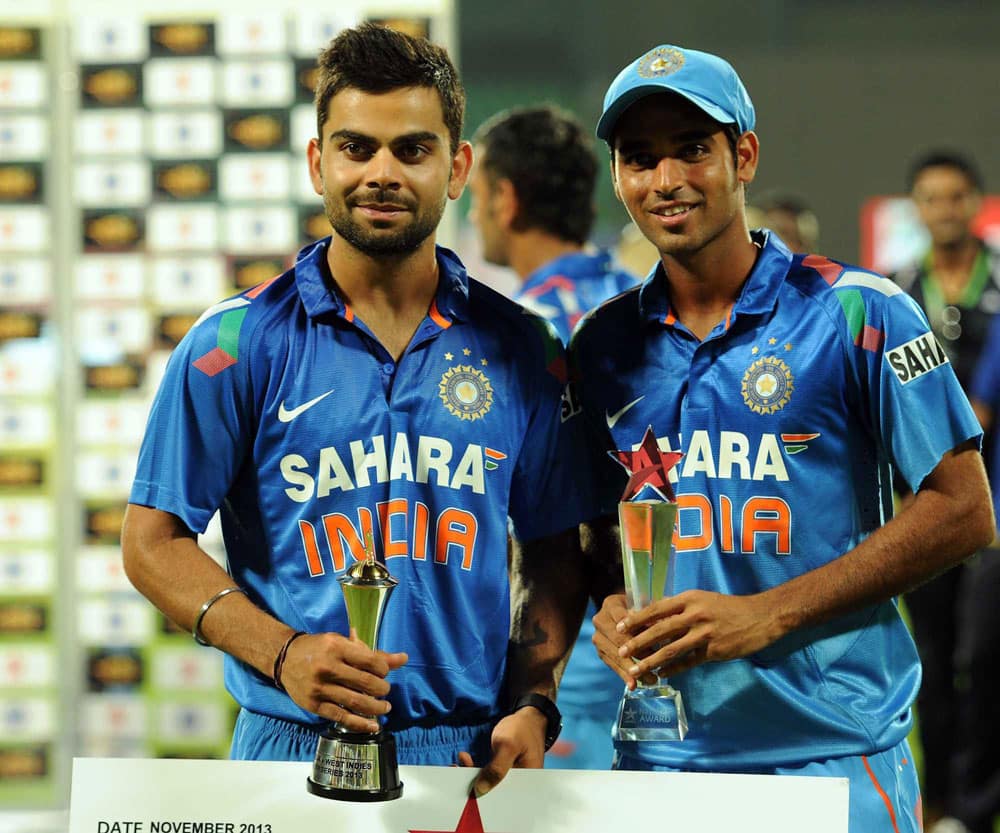 Indian cricketer Virat Kohli (Man of the match) and Bhuvaneshwar Kumar awarded for exceptional fielding with their trophies during the India-West Indies 1st ODI in Kochi.