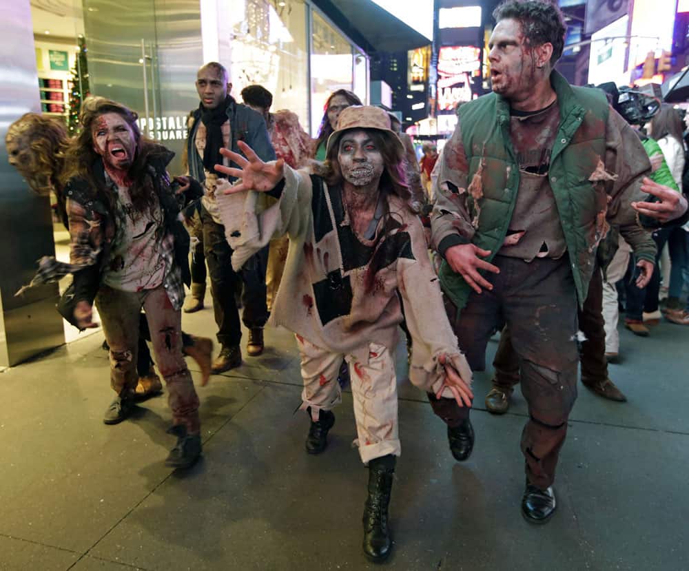 Xbox characters dressed as zombies parade through Times Square in advance of the midnight launch of Microsoft`s Xbox One video game console.