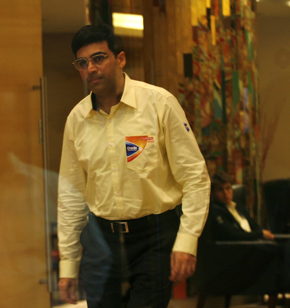Reigning world chess champion Viswanathan Anand of India walks into the playroom before the ninth game against Norway`s Magnus Carlsen, during the chess world championships in Chennai.