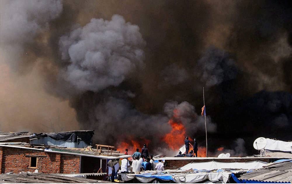 Fire fighters trying to douse a major fire that broke out in Ambedkar Nagar slum in south Mumbai.