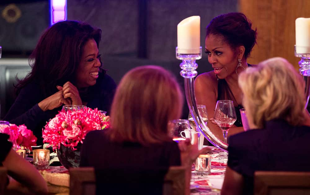 First lady Michelle Obama, right, talks with Oprah Winfrey during a dinner in honor of the Presidential Medal of Freedom awardees at the Smithsonian Museum of American History in Washington.