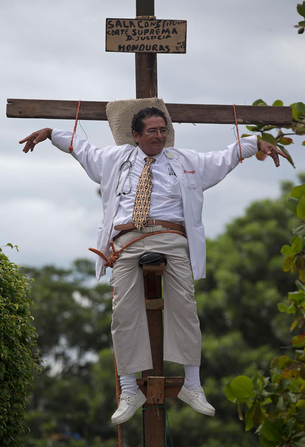 Francisco Pagoada hangs from a cross, with some support, as part of his protest against the Supreme Court that denied Pagoada`s request to run as an independent candidate for mayor, in Tegucigalpa, Honduras.