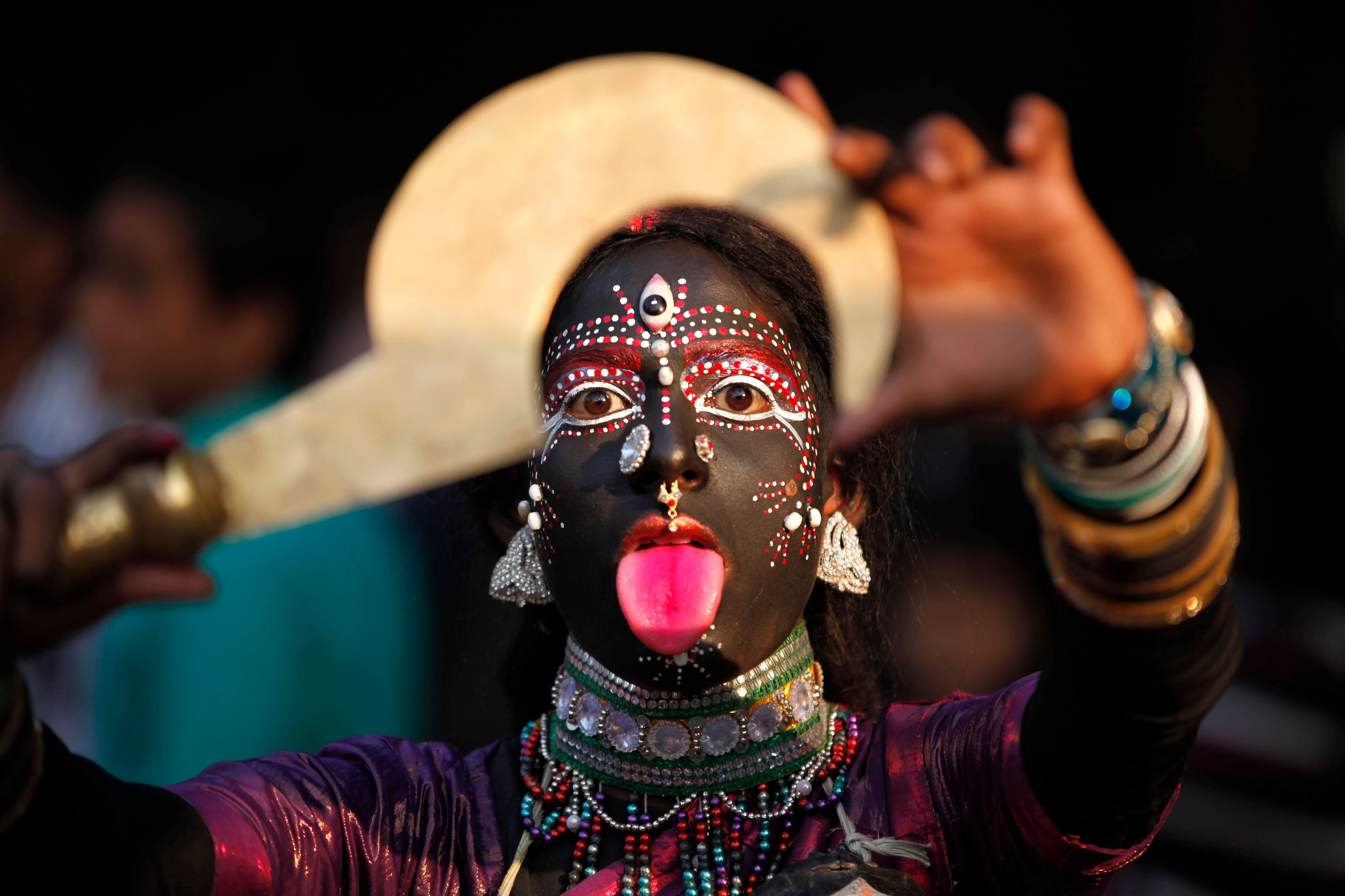 A folk artist from India’s northern Uttar Pradesh state performs during a procession held as part of the ongoing all India multilingual short play, folk dance competition and theatre seminar in Allahabad.