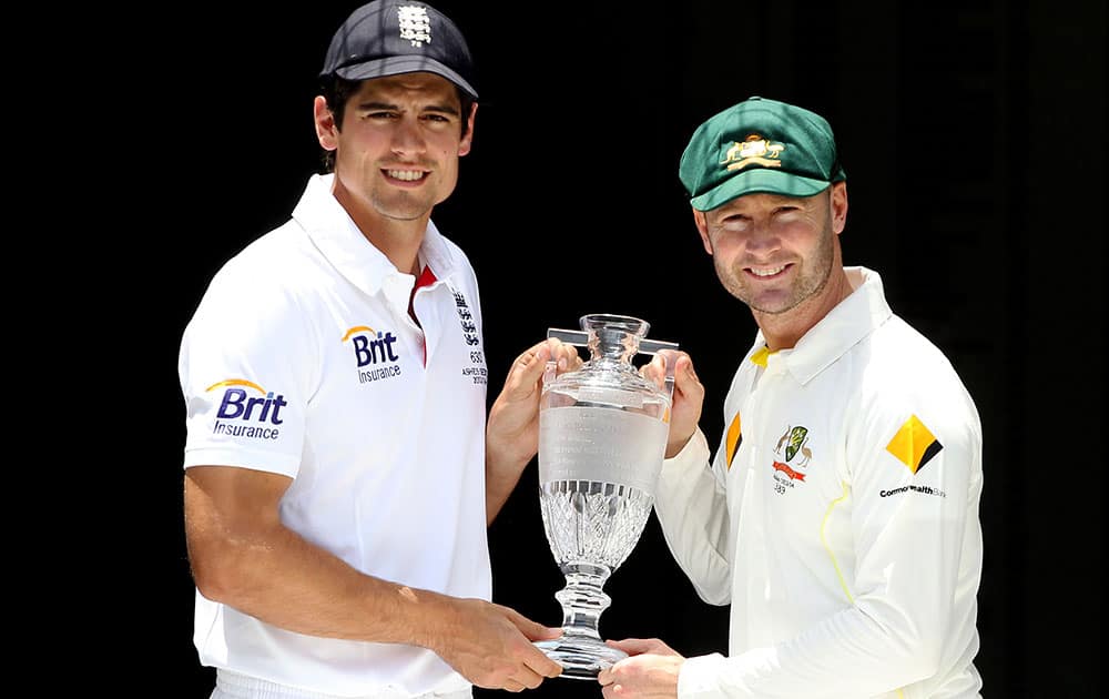 England captain Alastair Cook, left, and Australian captain Michael Clarke pose with the Ashes Trophy on the eve of the first test in the Ashes Series between England and Australia, in Brisbane, Australia.
