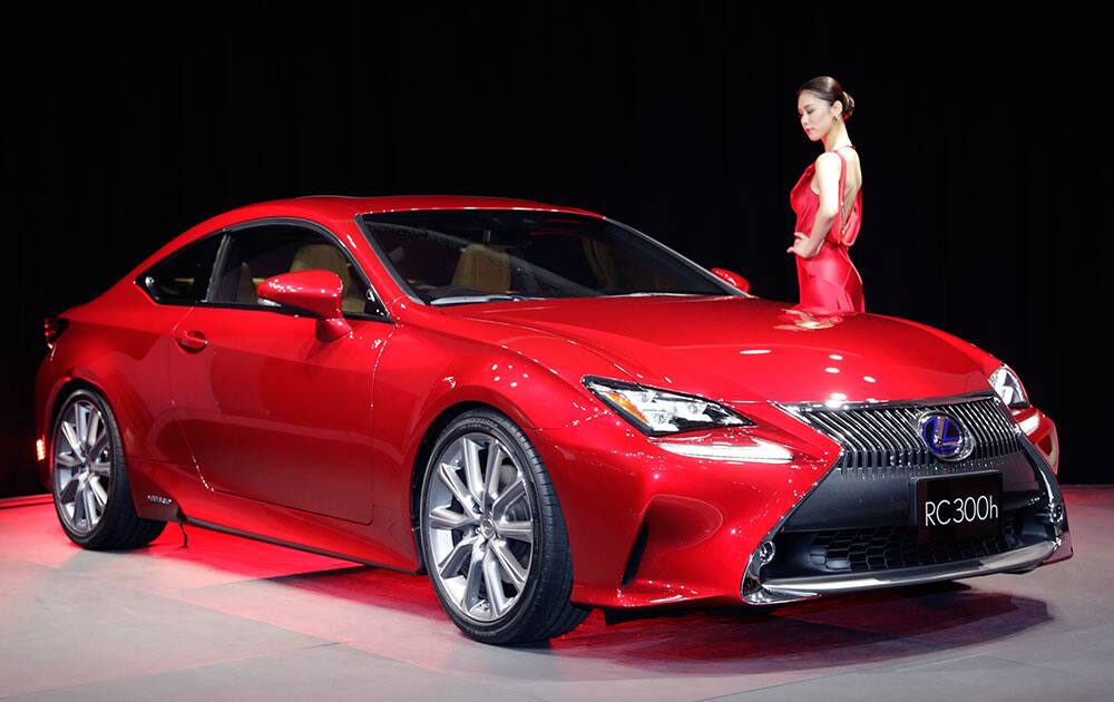Lexus Ambassador Riyo Mori poses with Lexus RC 300h hybrid coupe at the media preview for the Tokyo Motor Show.