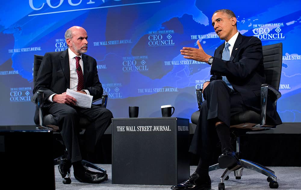 President Barack Obama gestures as he answers a question from Wall Street Journal Washington bureau chief Gerald Seib during the Wall Street Journal CEO Council annual meeting in Washington.