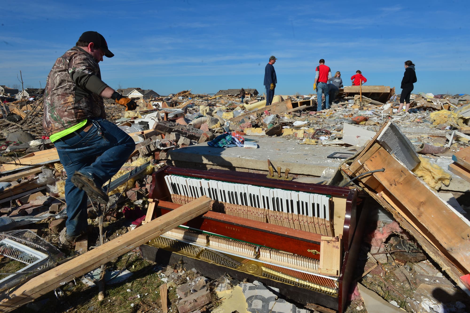 A piano lays battered as homeowners dig out what they can Tuesday, Nov. 19, 2013, in Washington, Ill., after more than 1,000 homes were devastated by a F4 tornado that passed through Sunday.