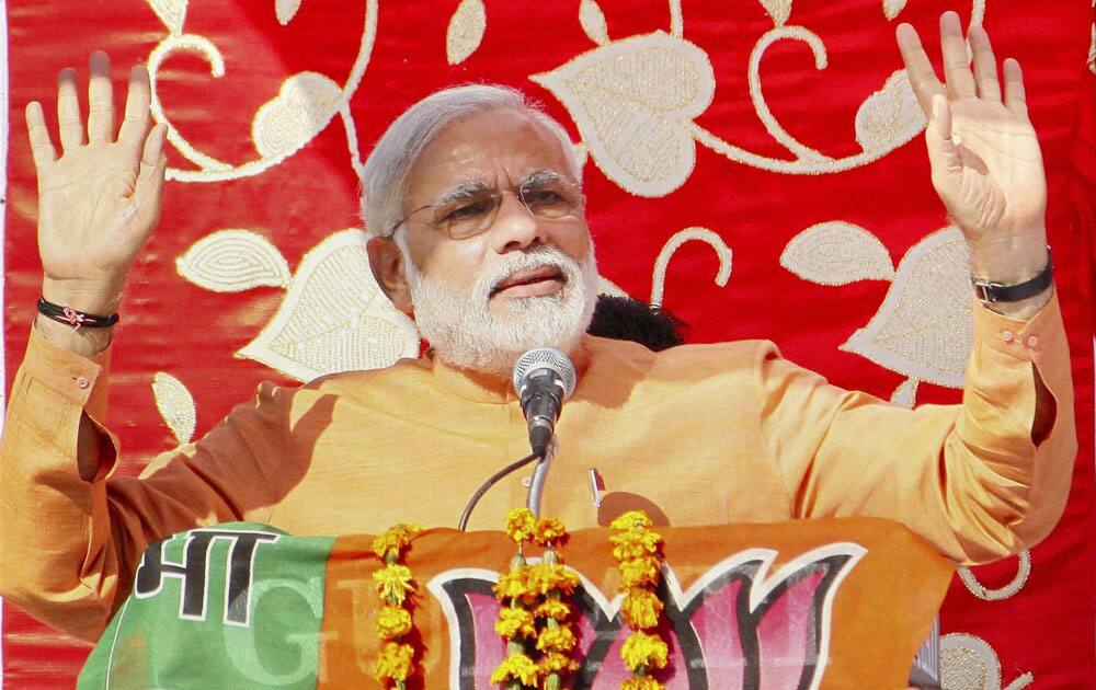 BJP Prime Ministerial candidate & Gujarat Chief Minister Narendra Modi addressing an election campaign rally at Bandikui, Rajasthan.