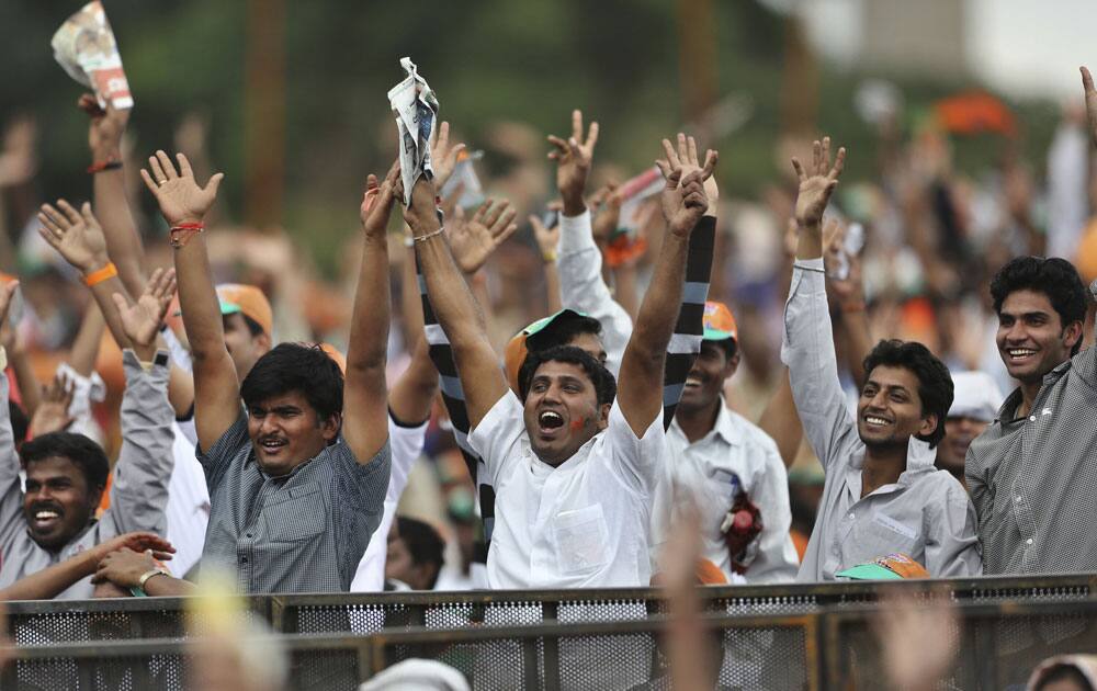 Supporters of India`s main opposition Bharatiya Janata Party (BJP)`s prime ministerial candidate Narendra Modi cheer for their leader at a public rally in Bangalore.