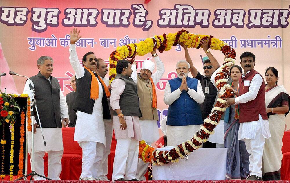 BJP` Prime Ministerial candidate Narendra Modi being garlanded during an election rally in Chhatarpur, Madhya Pradesh.