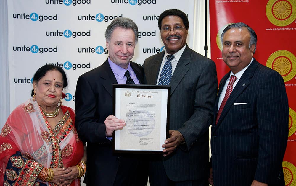 Unite4:good founder Anthony Melikhov, center, receives New York State Assembly Citation from New York State Assemblyman William Scarborough, right, flanked by Uma Sengupta, District Leader Queens, left, and Roger Sengupta at the Unite4:good New York City launch event to promote revolutionary movement for humanity, in the Flushing section of the Queens borough of New York.