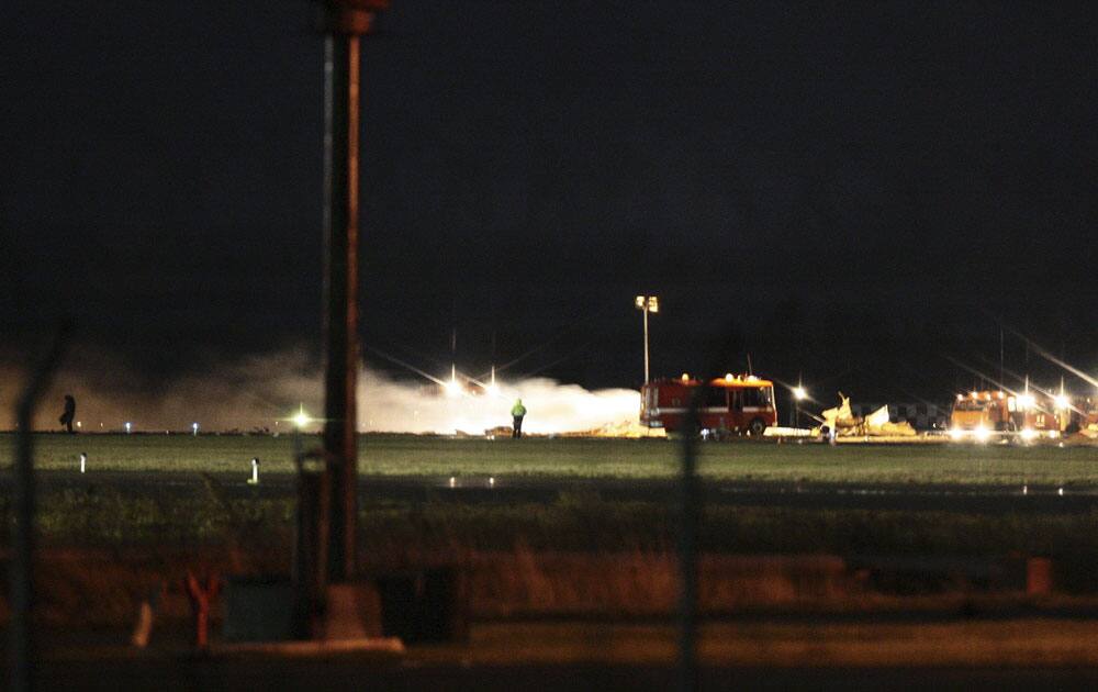 View of debris at the crash site of the Russian passenger airliner, Boeing 737, near Kazan, the capital of the Tatarstan republic, about 720 kilometers (450 miles) east of Moscow, early Monday, Nov. 18, 2013.