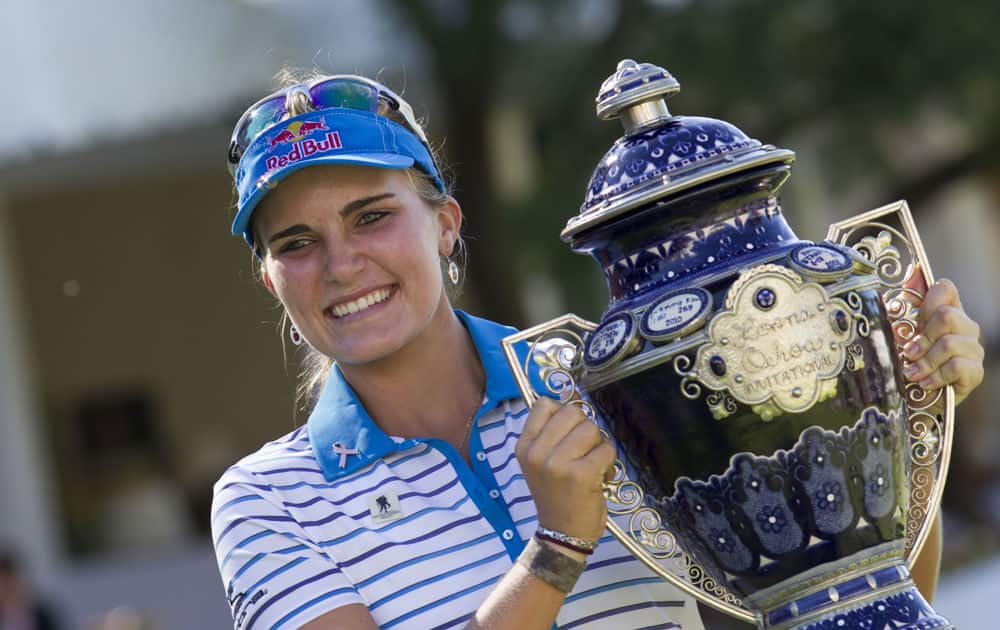 Lexi Thompson holds up her trophy after she won this year`s Lorena Ochoa Invitational in Guadalajara, Mexico.