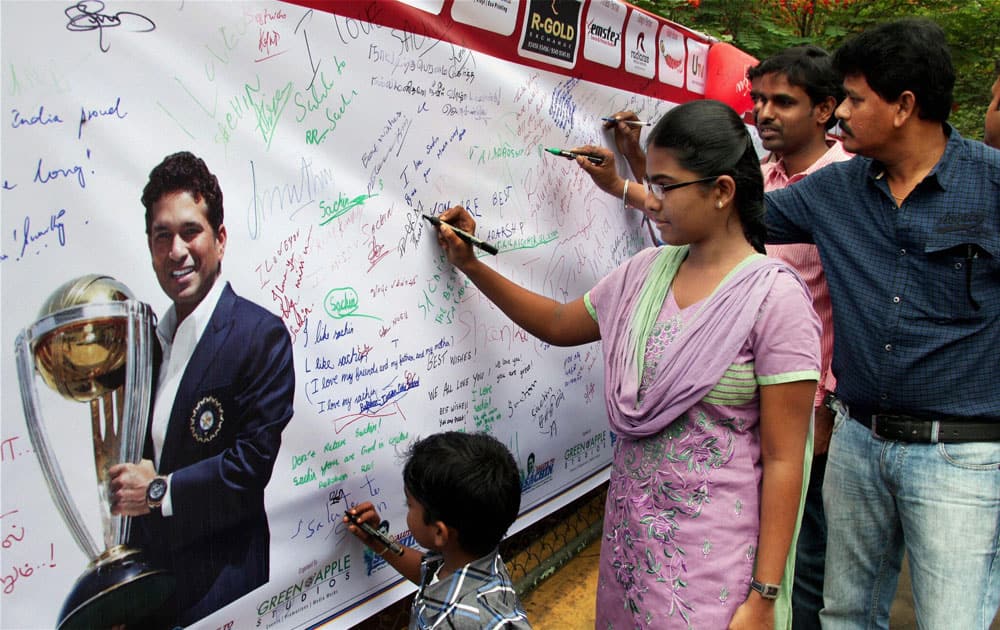 Sachin Tendulkar`s fans sign a banner with his photograph wishing him good luck in Coimbatore.