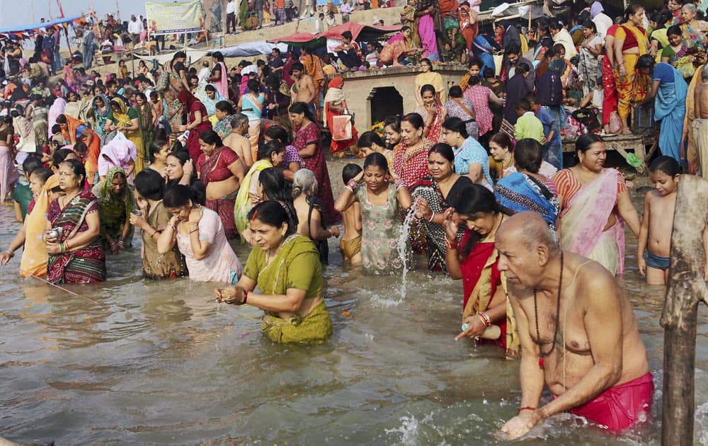 Devotees take a holy dip in river Yamuna on the occasion of Kartik Purnima at Gaughat in Allahabad.